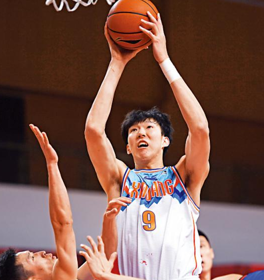 周琦膺CBA月度最佳防守球员，新疆队主将周琦（白衣）在比赛中上篮 中网体坛,oubili.com